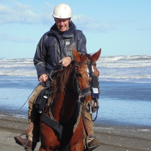 Fig.5b. Hanson in the saddle with his 11-year-old half-bred mare wearing his copy of a Bedouin noseband attached to the head collar supporting the exercise video-endoscope in the mare’s right nasal cavity. The audio-recorder lies above the white label. 2015 © Robert Cook, photo: Fridtjof Hanson 